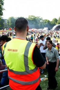 Security guard watches the crowd during one of the summer outdoor music festivals.