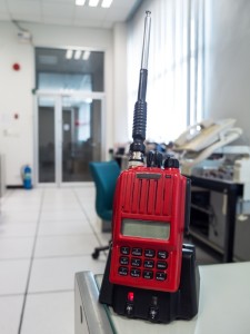 Red emergency two way radio on desk in factory.